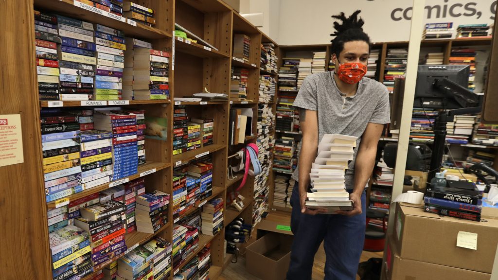 Dan Loftus carries books at Half Price Books in Mayfield Heights, Ohio on May 11, 2020